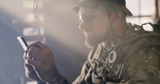 istock Military man using smartphone inside grungy building 1279117631