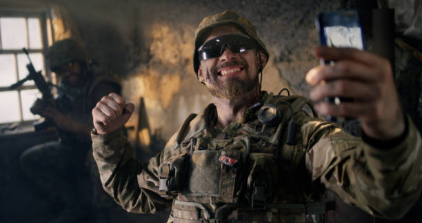 istock Military man using smartphone inside grungy building 1279117661