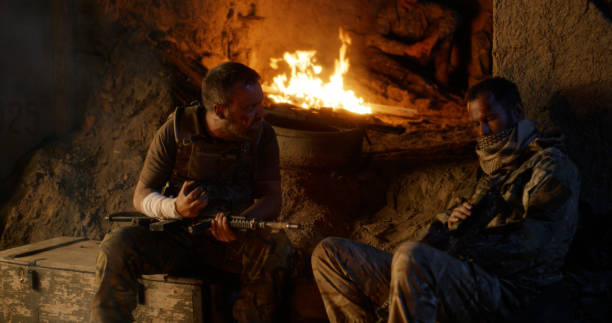 istock Angry military men resting near fire 1279117717