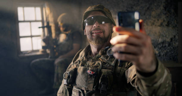 istock Military man using smartphone inside grungy building 1279117731