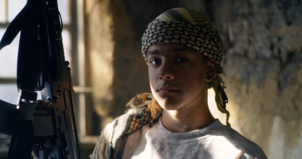 istock Young terrorist with weapon in shabby room 1279117871