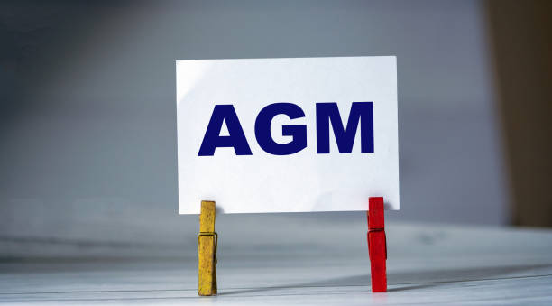istock Reminder sticky note with clothes pin on table. Sticky note with word AGM. Business strategy 1279117917