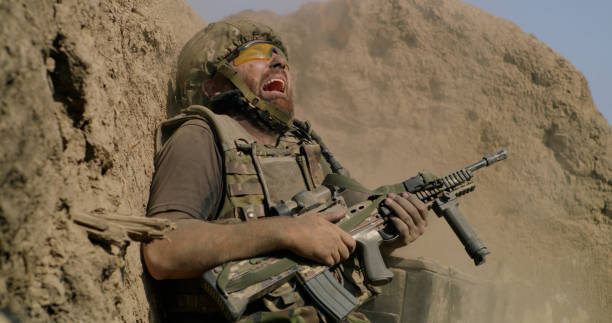 istock Scared soldier firing gun in air 1279117981
