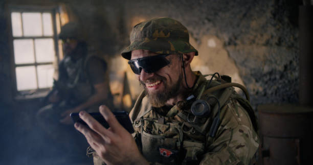 istock Military man using smartphone inside grungy building 1279118083