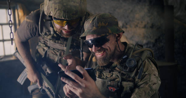 istock Male soldiers using smartphone together 1279118132
