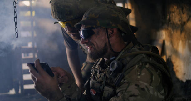 istock Male soldiers using smartphone together 1279118146