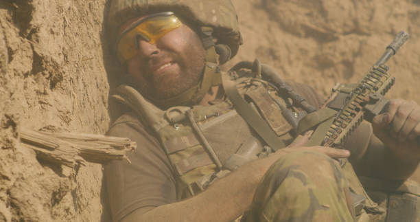 istock Scared fighter hiding in trench during war 1279118157