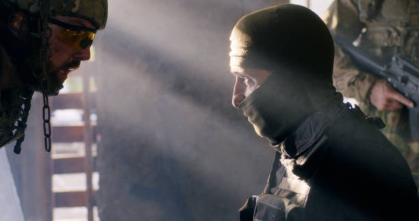 istock Angry soldier interrogating mature terrorist 1279118175