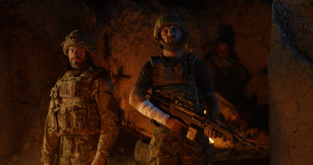 istock Confident soldiers standing against fire at night 1279118184