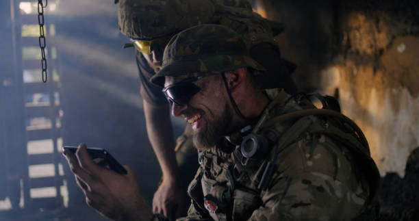 istock Male soldiers using smartphone together 1279118193