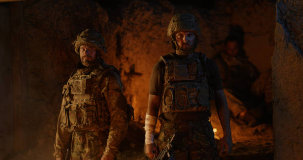 istock Confident soldiers standing against fire at night 1279118195