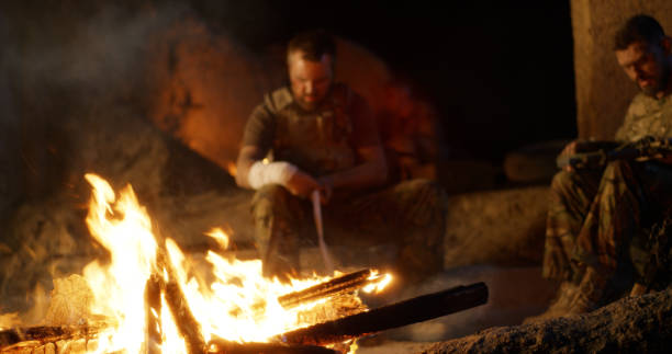 istock Angry military men resting near fire 1279118254