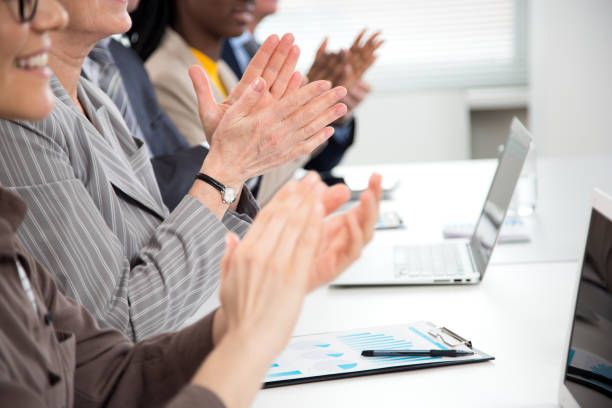 istock Business people clapping hands at business seminar. 1279118335