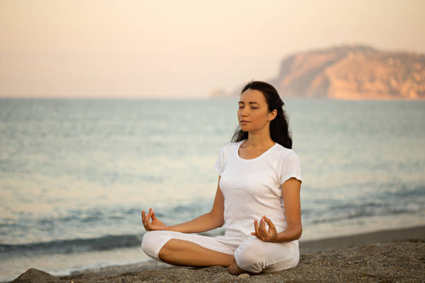 istock Yoga concept. Female practicing yoga at the beach. 1279118363