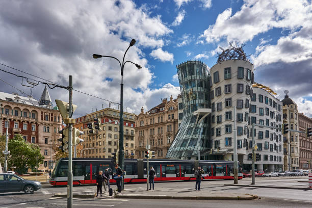 Prague Prague, Czech Republic - September 30, 2019: pedestrians, traffic and a tram on the Rasinovo Nabr. Road. in the background the Dancing House of Prague. dancing house prague stock pictures, royalty-free photos & images