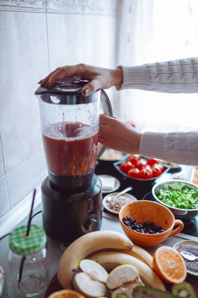 istock Preparing healthy fruit and vegetable smoothie in the kitchen 1279119582