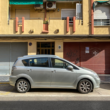 Valencia, Spain - September 30, 2020: Silver colored Toyota car model Corolla Verso parked in the street. The Japanese manufacturer produced it from 1997 until 2009