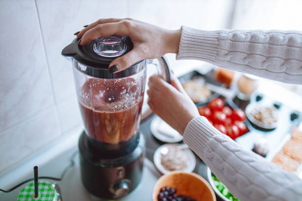 istock Preparing healthy fruit and vegetable smoothie in the kitchen 1279119724