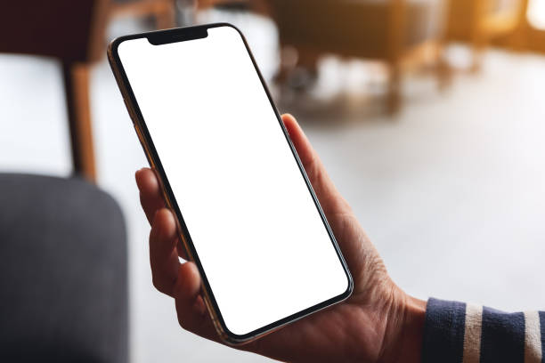 istock a woman holding mobile phone with blank white desktop screen 1279120086