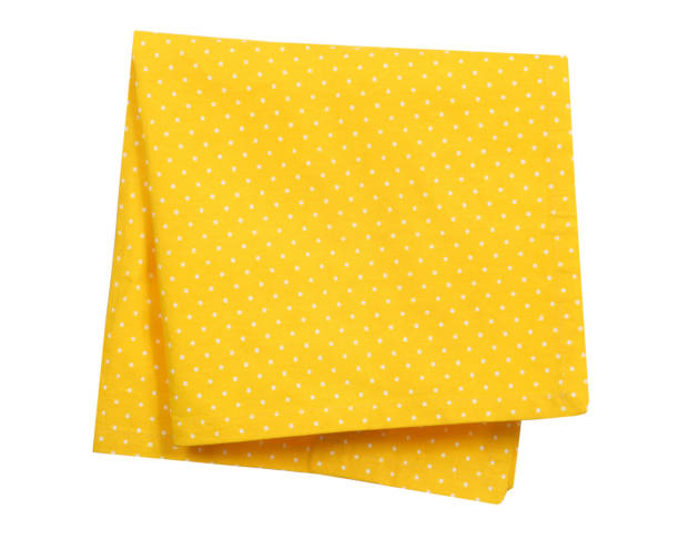 Yellow folded kitchen towel isolated Household napkin.Tablecloth front view. Yellow folded kitchen towel isolated on white.Household napkin.Tablecloth object. mustard yellow fabric stock pictures, royalty-free photos & images