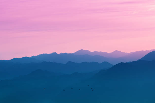 Silhouette of mountain ranges against the sunset sky