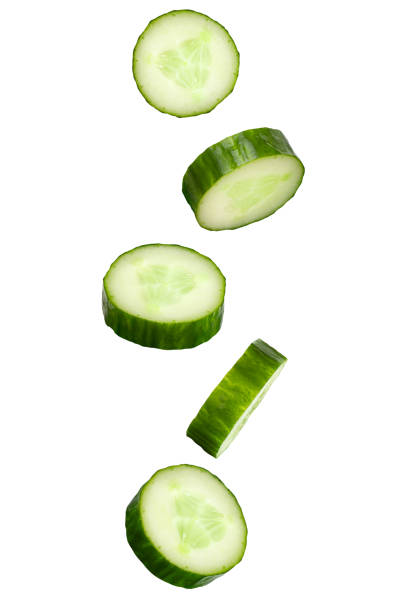 istock Falling cucumber slices isolated on a white background with clipping path. Flying vegetables 1279121074