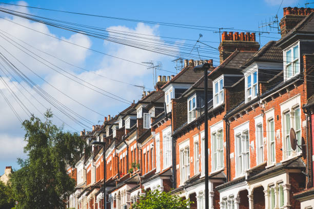 English terraced houses in Crouch End, London, with multiple overhead cables above street Row of traditional English terraced houses in Crouch End, London, with multiple overhead cables above street window chimney london england residential district stock pictures, royalty-free photos & images