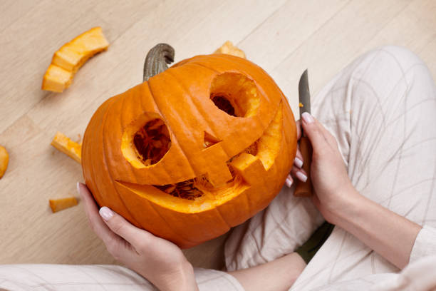 istock Cutting scary pumpkin jack for Halloween 1279124760