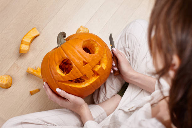 istock Cutting scary pumpkin jack for Halloween 1279124783