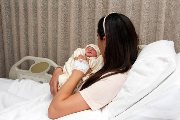 istock Newborn baby with mother 1279126369