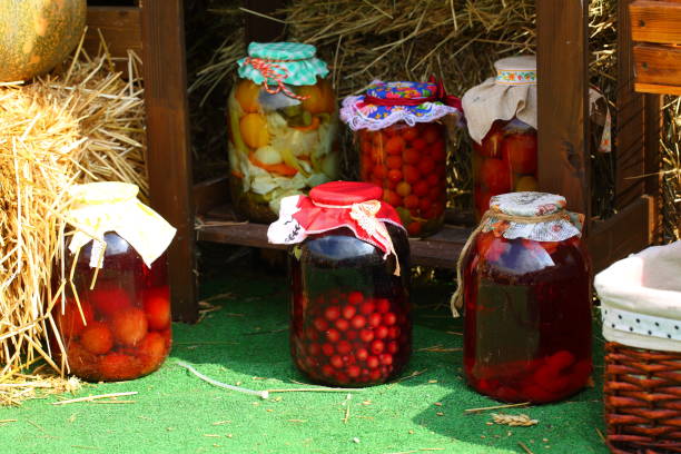 istock Canned tomatoes and cucumbers in glass jars 1279127950