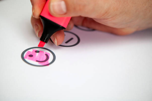 Smiley face icon being colored in for customer sales research or user experience with copy space