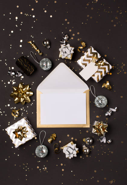 Christmas composition. Gold and silver decorations, mirror disco balls, gifts on  dark black background.