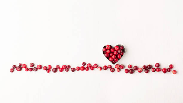 Red cranberry on white background. Healthy food concept. Raw organic fresh Cranberry berries, cowberry or lingonberry on white wooden background. Winter cranberry concept. Healthy lifestyle. bearberry stock pictures, royalty-free photos & images