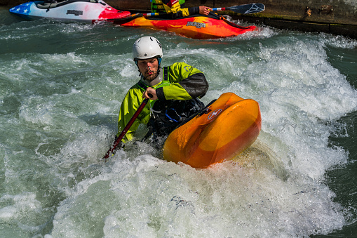 Augsburg, Germany - June 16, 2020: Whitewater kayaking training, extreme kayaking. A guy in a kayak sails on the Eiskanal in Augsburg Germany