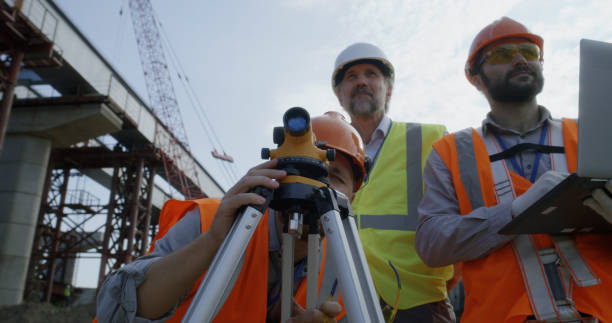 istock Surveyors measuring construction site with theodolite 1279128937