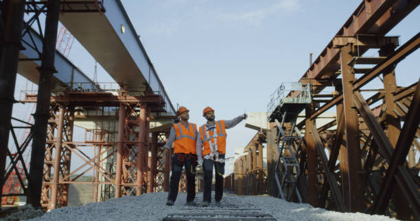 istock Builders walking near unfinished bridge 1279129160
