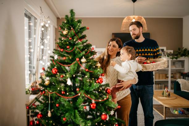 istock Family decorating christmas tree 1279129163