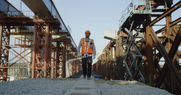 Foreman walking and speaking on walking talkie