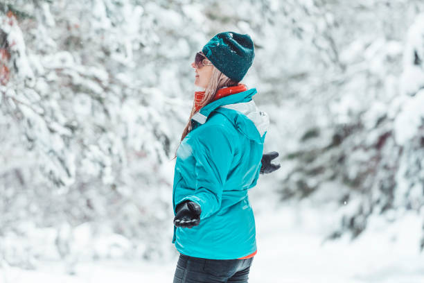 istock Woman standing out in falling snow in winter 1279129481