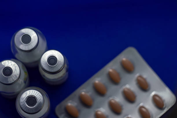 istock Vaccine bottles with pills high view 1279130298