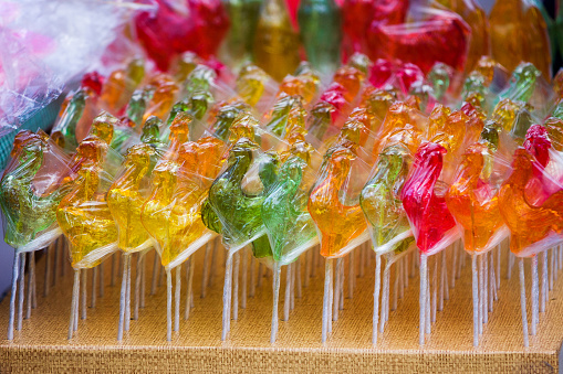 Photo of colorful yellow, pink, green, orange lollipops assorted
