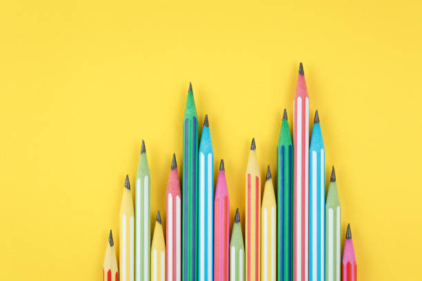 istock multicolored pencils on yellow isolated background 1279133295