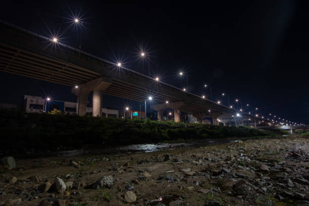 istock A road bridge with beautiful streetlights next to a small stream. 1279135177