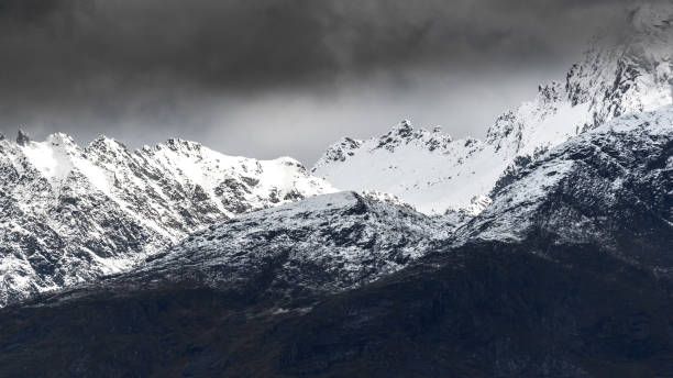 istock Dark clouds and snow on the mountain. 1279135370