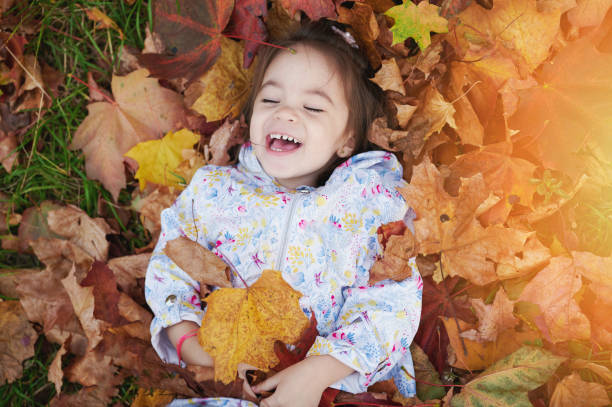 istock Happy smile kid in yellow leaf 1279136109