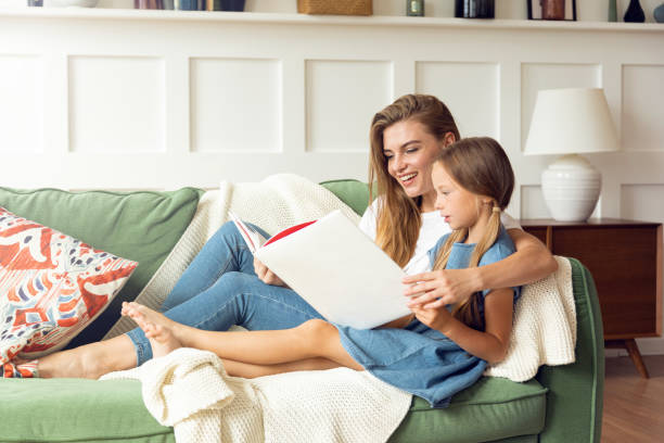 istock Young mother with little daughter  reading a book together 1279138041