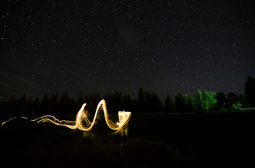 Long exposure shot. Light writing abstract, under the stars, in the mountain region