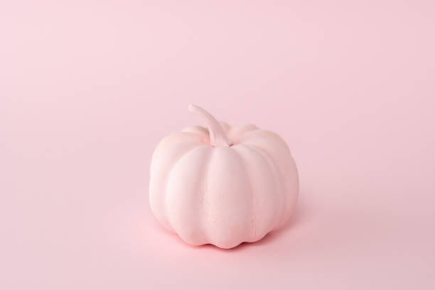 istock Pink pumpkin on a pastel pink background. Minimal Halloween concept. 1279138481