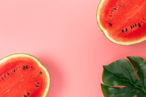 istock Watermelon with palm tree leaf on pink background. Creative minimal summer concept. 1279138497